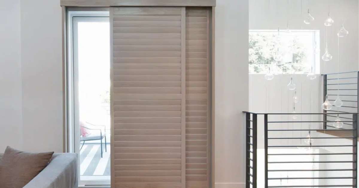 Sliding door with adjustable shutters offering versatile light control and enhanced privacy features